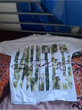 Studio White Short Sleeve Tee with Green Graphic and Script Logo